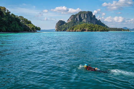 Tropical islands view with snorkeling driving tourist at ocean blue sea water and white sand beach, Krabi Thailand nature landscapeの写真素材