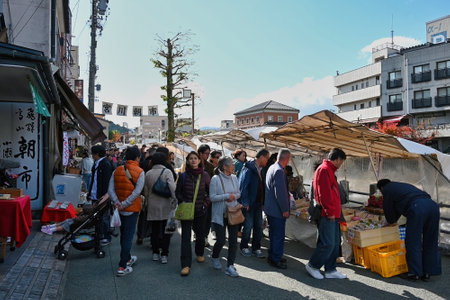 Takayama, Japan - November 4, 2019 : Takayama Asaichi Morning Market along with  city skyline with Miyakawa riverのeditorial素材
