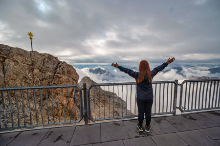 Zugspitze Peak top of Germany and Alps mountain range with woman tourist, Garmisch Partenkirchen...