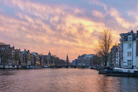 Amsterdam Netherlands, sunset city skyline of Dutch house at canal waterfrontの写真素材