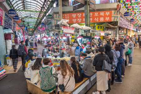 Seoul, South Korea - November 11, 2022 : shop and street food stall with many tourist at Gwangjang Marketのeditorial素材