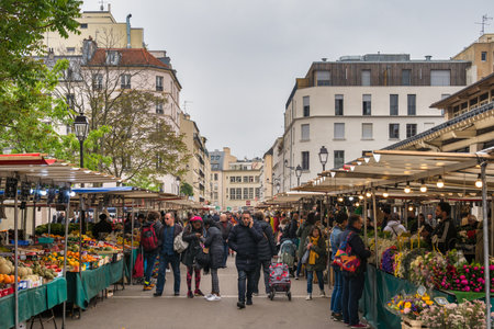 Paris, France - May 14, 2023: many tourist walking and shopping at Aligre Market in Parisのeditorial素材