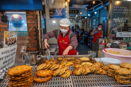 Seoul, South Korea - November 11, 2022 : shop and street food stall with many tourist at Gwangjang Marketのeditorial素材