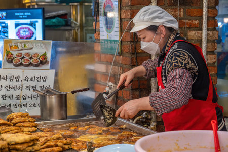 Seoul, South Korea - November 11, 2022 : shop and street food stall with many tourist at Gwangjang Marketのeditorial素材