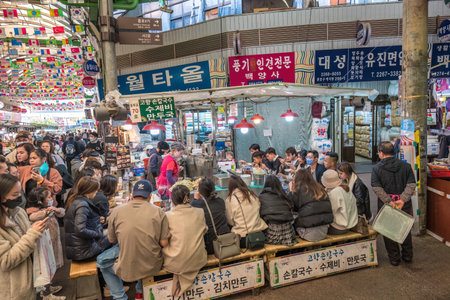 Seoul, South Korea - November 11, 2022 : shop and street food stall with many tourist at Gwangjang Marketのeditorial素材