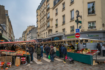 Paris, France - May 14, 2023: many tourist walking and shopping at Aligre Market in Parisのeditorial素材