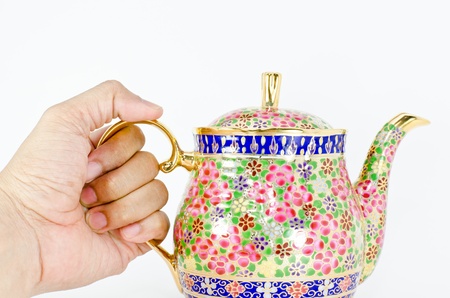 hand holding a jar of thai teaの写真素材