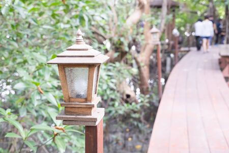 Lamp along a wooden walkwayの写真素材