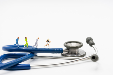 Miniature people running stethoscope. Health care and medical.の写真素材