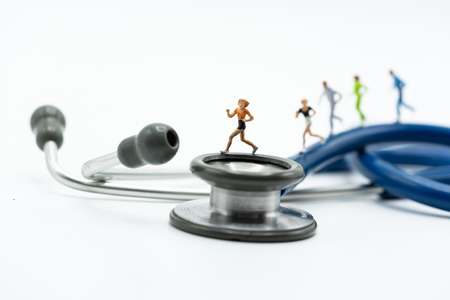 Miniature people running stethoscope. Health care and medical.の写真素材