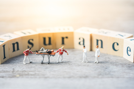 Miniature people, emergency medical team with unconcious  patient on word blocksの写真素材