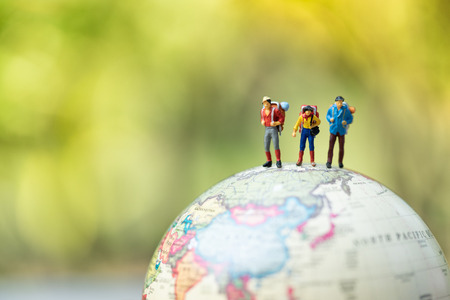 Miniature people: group of traveler on earth globe ,traveling around the world,  exploring on earth background concept.の写真素材