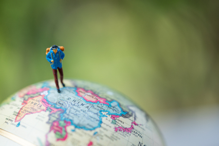 Miniature people: group of traveler on earth globe ,traveling around the world,  exploring on earth background concept.の写真素材