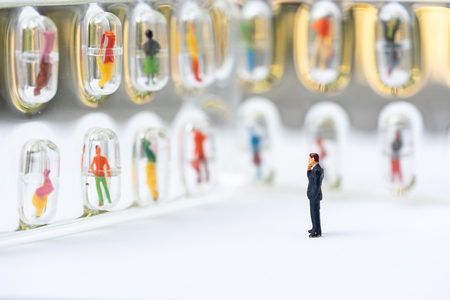 Miniature people, recruiters finding the candidates on the wall. Human resource concept, recruiting, hiring process.の写真素材