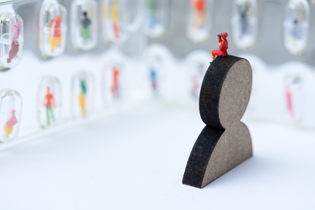 Miniature people, recruiters on wooden people sign for finding the candidates on the wall. Human resource concept, recruiting, hiring process.の写真素材