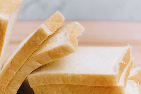 Sliced bread bake on wooden tray. Simple breakfast