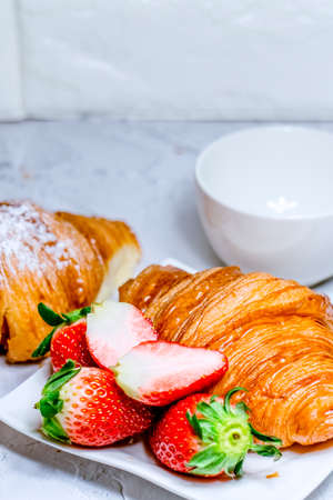 Continental breakfast with croissants. Coffee and fresh strawberriesの写真素材