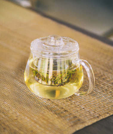 The teapot is placed on the mat.の写真素材