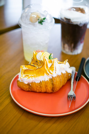 Croissant, homemade butter, topped with cream and lemon sauce