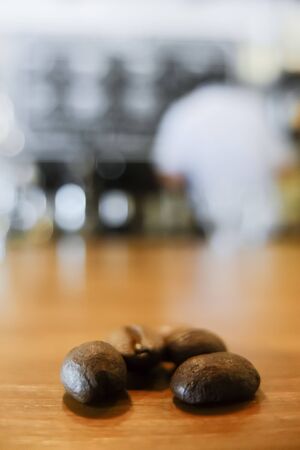Coffee beans on table and baristaの写真素材
