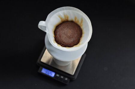 Drip brewing, filtered coffee, or pour-over is a method which involves pouring water over roasted, ground coffee beans contained in a filterの写真素材