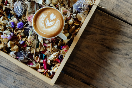 Coffee cup with latte art on the wood table.の写真素材