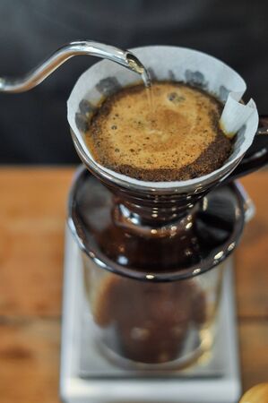 Drip brewing, filtered coffee, or pour-over is a method which involves pouring water over roasted, ground coffee beans contained in a filter.の写真素材
