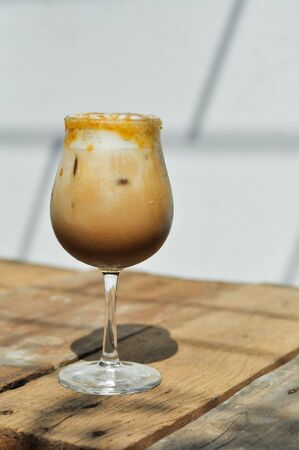 Cold coffee refreshment drink on wood desk in cafeの写真素材