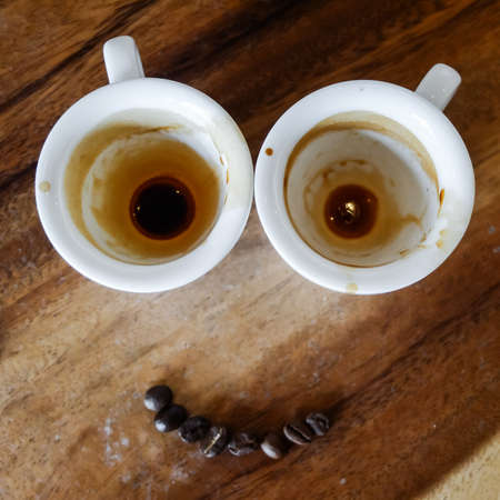 Empty coffee cup after drink on wood table.の写真素材