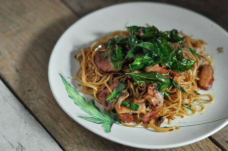 Fusion food, Chili chinese noodle and bacon mixs hot basil.の写真素材