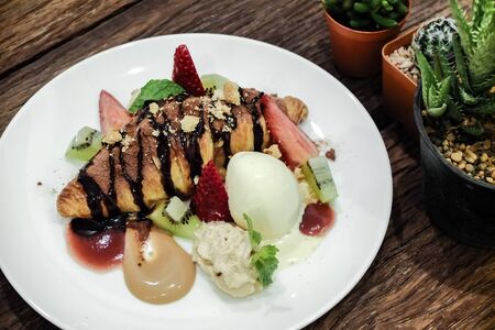 Croissants with strawberries kiwi and vanilla icecream.の写真素材