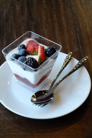Italian dessert panna cotta with fresh strawberries and blueberries.の写真素材