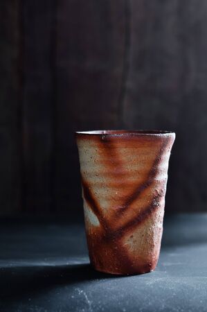 Ceramic Japanese teacup in the dark tone.の写真素材