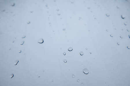 Rain drops and frozen water on window glass backgroundの写真素材