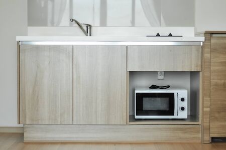 Contemporary kitchen design interior with wood and stainless steel material.の写真素材