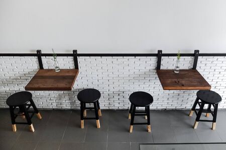 Cafe seating area with wooden table and chairs in minimal styleのeditorial素材