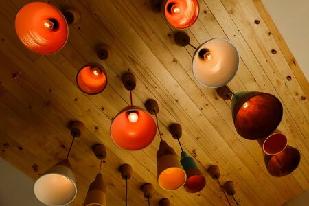 Colorful electric lamp hanging on the wood ceiling.の写真素材