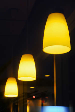 Electric lamp hanging from the ceiling on dark background.の写真素材