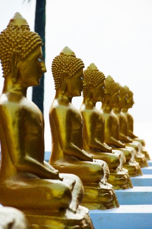 Gold Buddha on the beach in Ancient temple of Thailandの写真素材