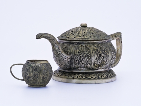 Antique tea pot and cups made metal, isolated on a white background.の写真素材