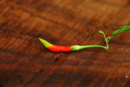 Fresh green and red peppers and spicy on wooden floors.の写真素材