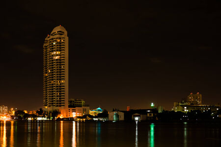 Riverside buildings at night in Bangkok, Thailand.の写真素材