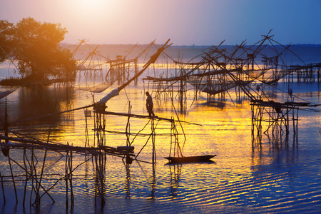 Silhouette of traditional fishing method using a bamboo square dip net in Patthalung, South of Thailand  taken in the morning の写真素材