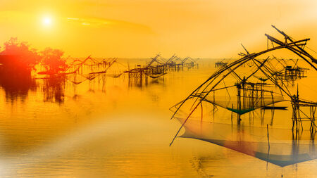 Silhouette of traditional fishing method using a bamboo square dip net in Patthalung, South of...