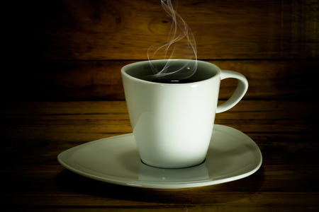 Coffee cup and saucer on a wood.の写真素材