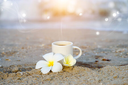 Coffee on the beach and frangipani flower.の写真素材
