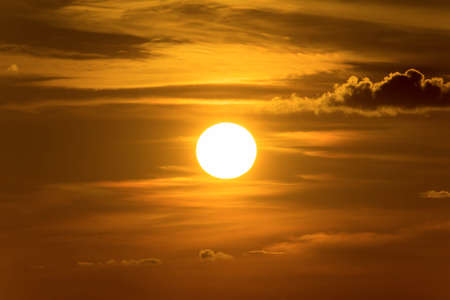 Big sun and orange sunset sky.