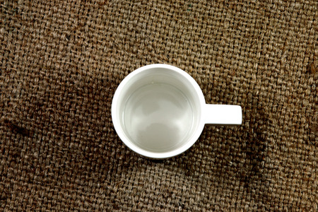 White coffee cup on a hemp sack.の写真素材