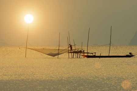 fisherman at the lake, Thailand.