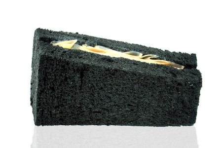 Black bread sandwich with ham and cheese.の写真素材